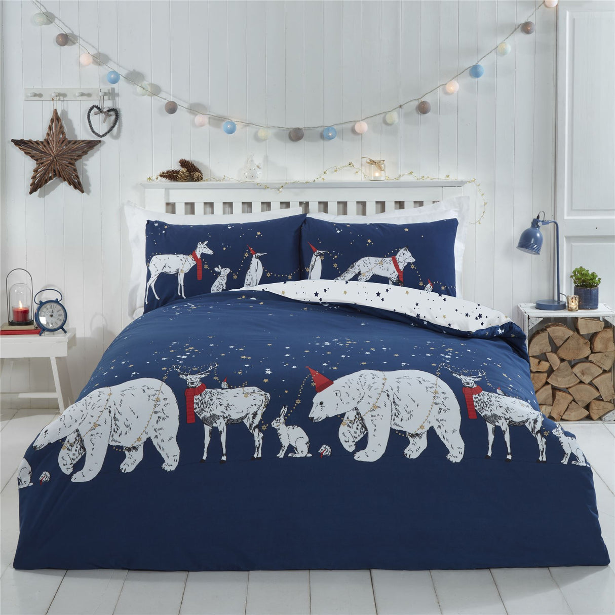 A vivid duvet set illustrating playful polar bears and friends parade under a starry midnight sky with deep blue and inky hues, accented by pops of red, featuring a reversible star print design