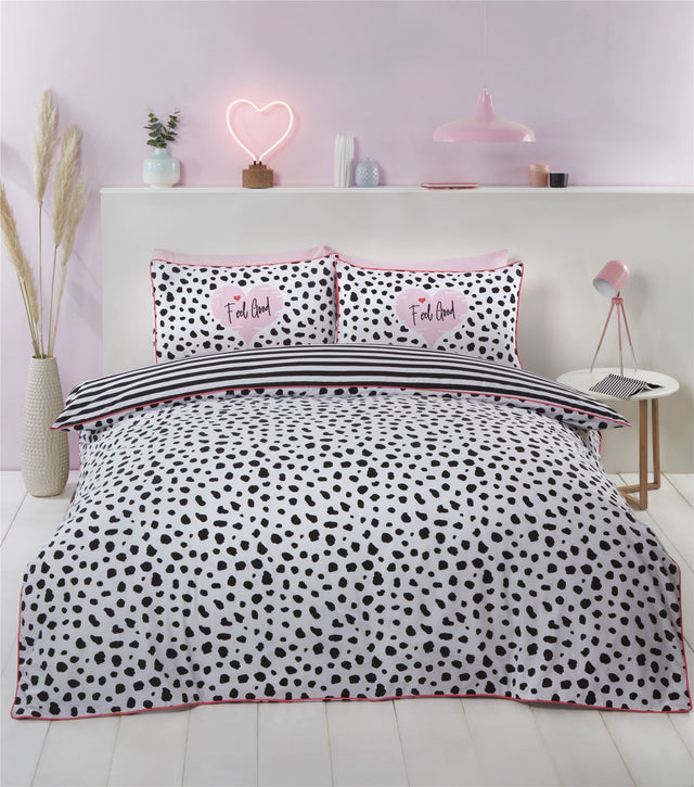 Colorful dalmation print duvet cover with bold pink trim and monochrome tones