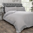 Close-up of Tia Trellis duvet cover showing the sophisticated plain design with delicate lace fringe detailing on the edges