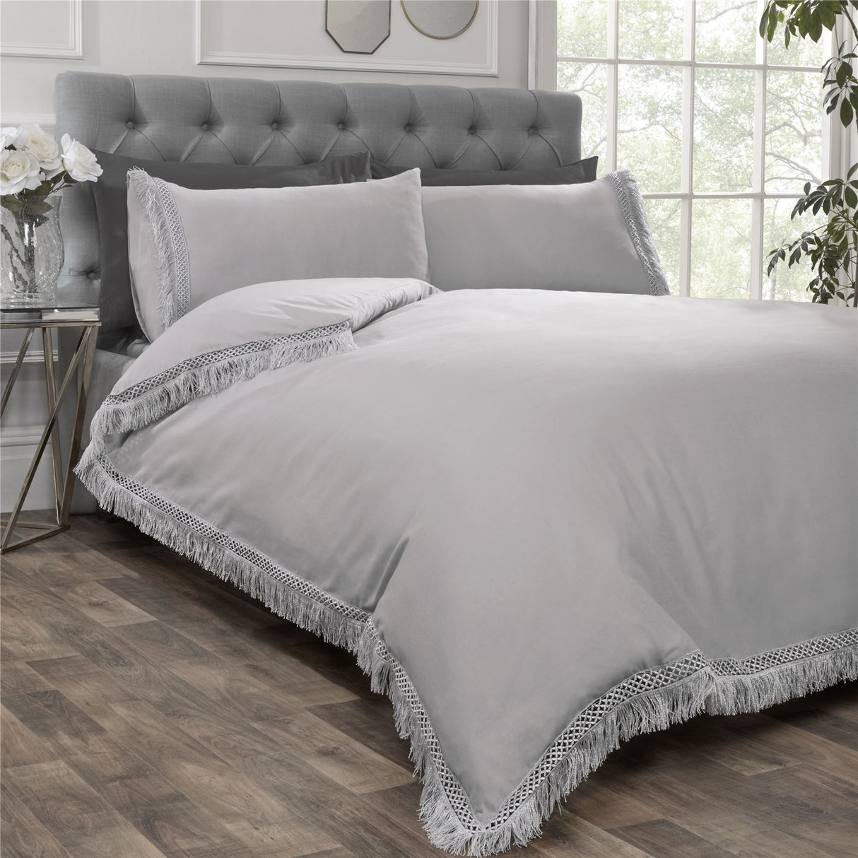 Close-up of Tia Trellis duvet cover showing the sophisticated plain design with delicate lace fringe detailing on the edges