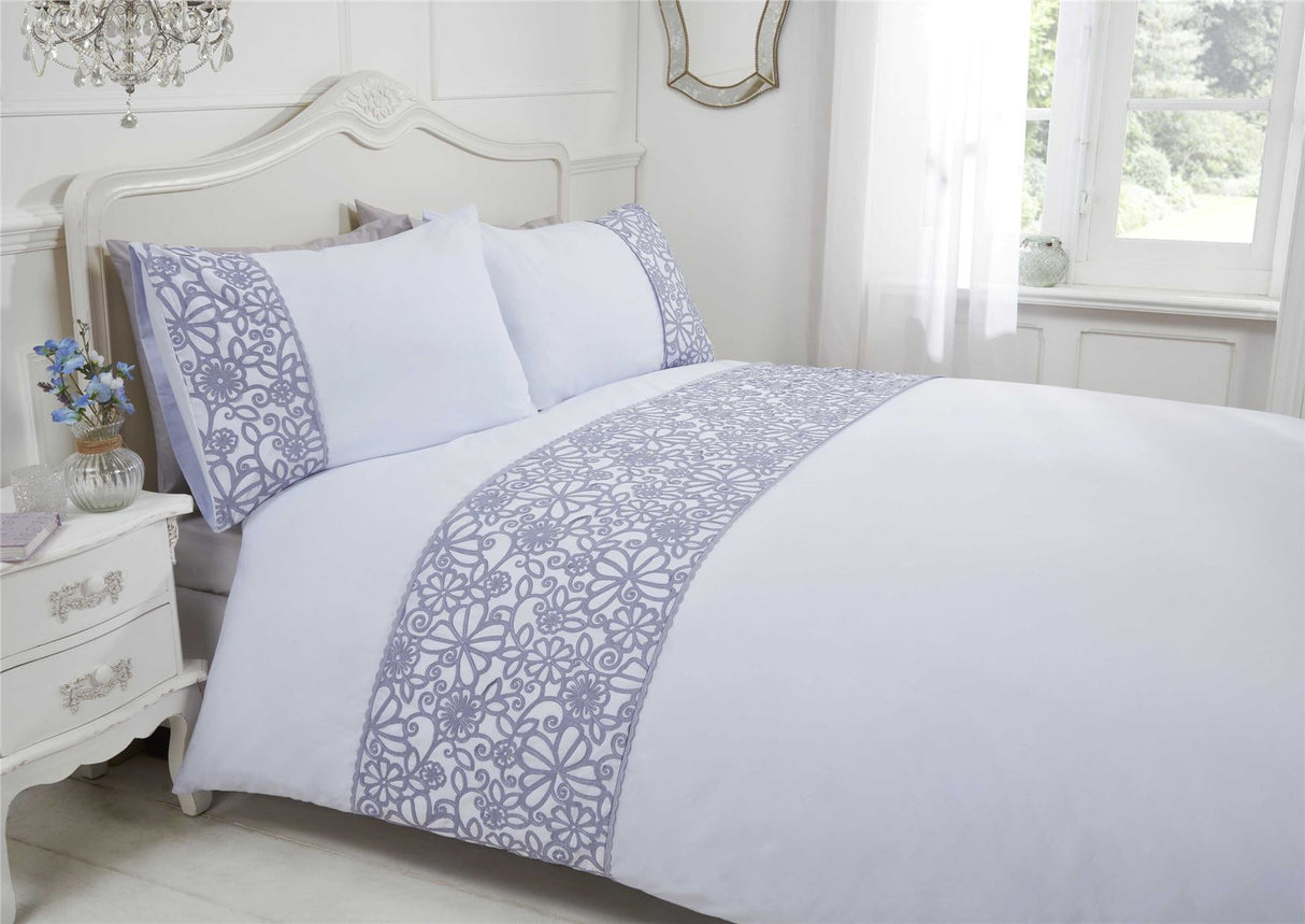 Close-up of the flower and butterfly design on the duvet cover with scalloped trim