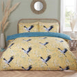 Close-up of the Cranes Duvet Set showcasing the delicate cranes in flight on an ochre backdrop, featuring a reversible lace pattern in teal for versatile styling