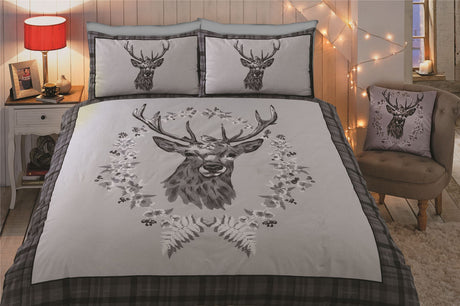Bold panel printed stag head surrounded by winter berries and foliage, with a robin perched on its antlers