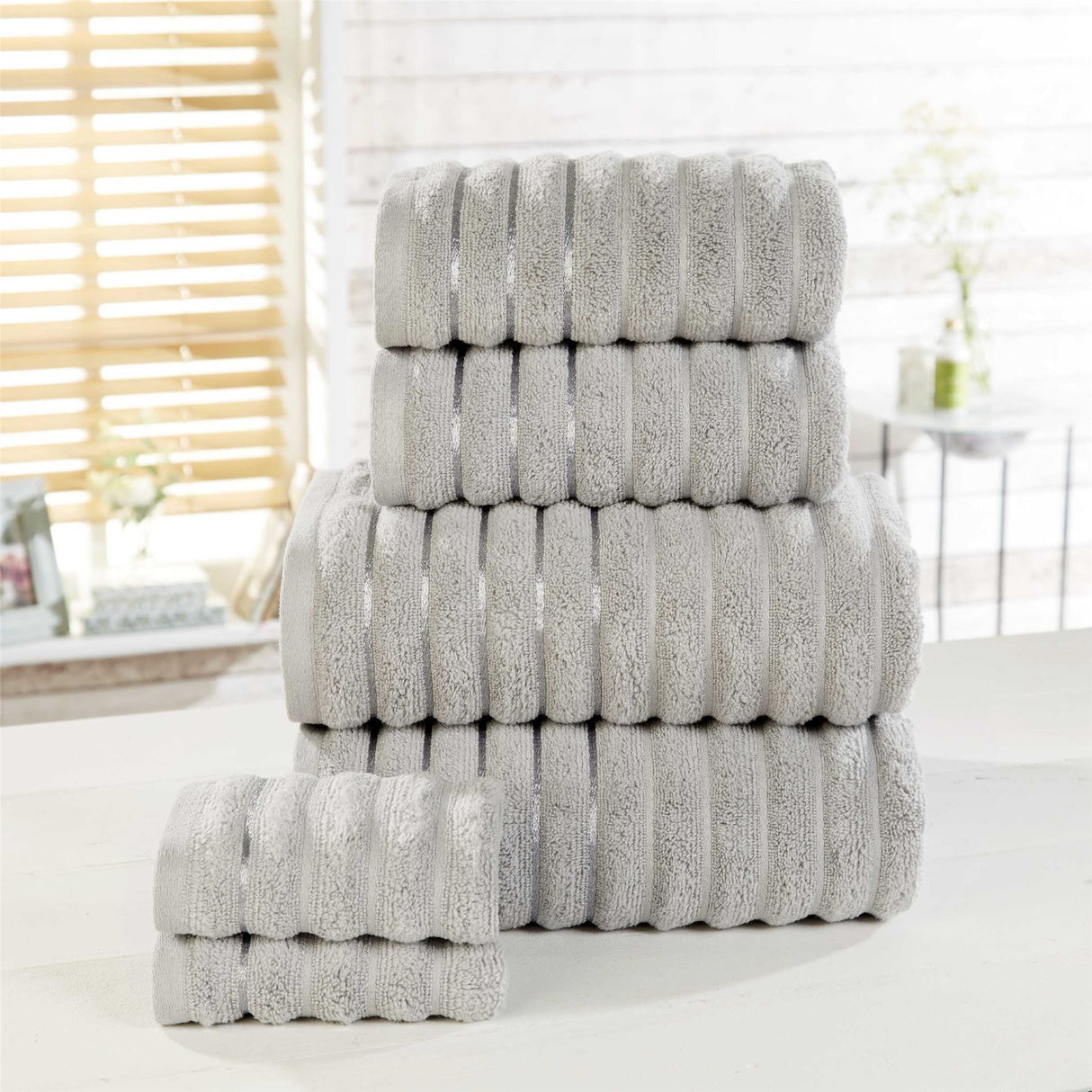 Large 90x140cm bath sheet with plush ribbed surface, stripe details, and silky sheen borders for a refined finish