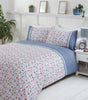 Close-up of the Penelope Duvet Set showcasing elegant spring flowers and vintage lace accents