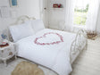 Matching pillowcases with embroidered hearts, pintucks, and detailed motifs for a cohesive bedroom look