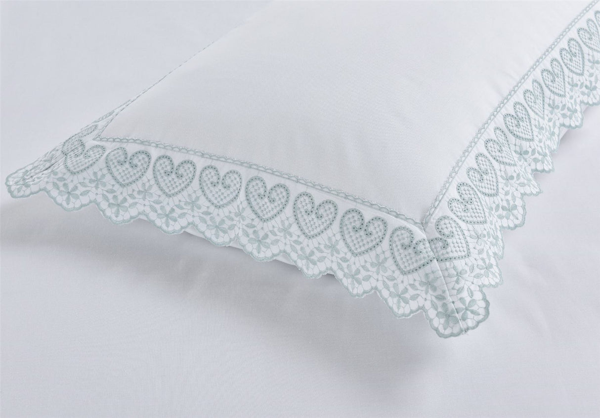 Serene Elise duvet cover showcasing charming heart motifs and fine lace edging, perfect for a sophisticated bedroom retreat