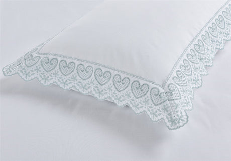 Serene Elise duvet cover showcasing charming heart motifs and fine lace edging, perfect for a sophisticated bedroom retreat