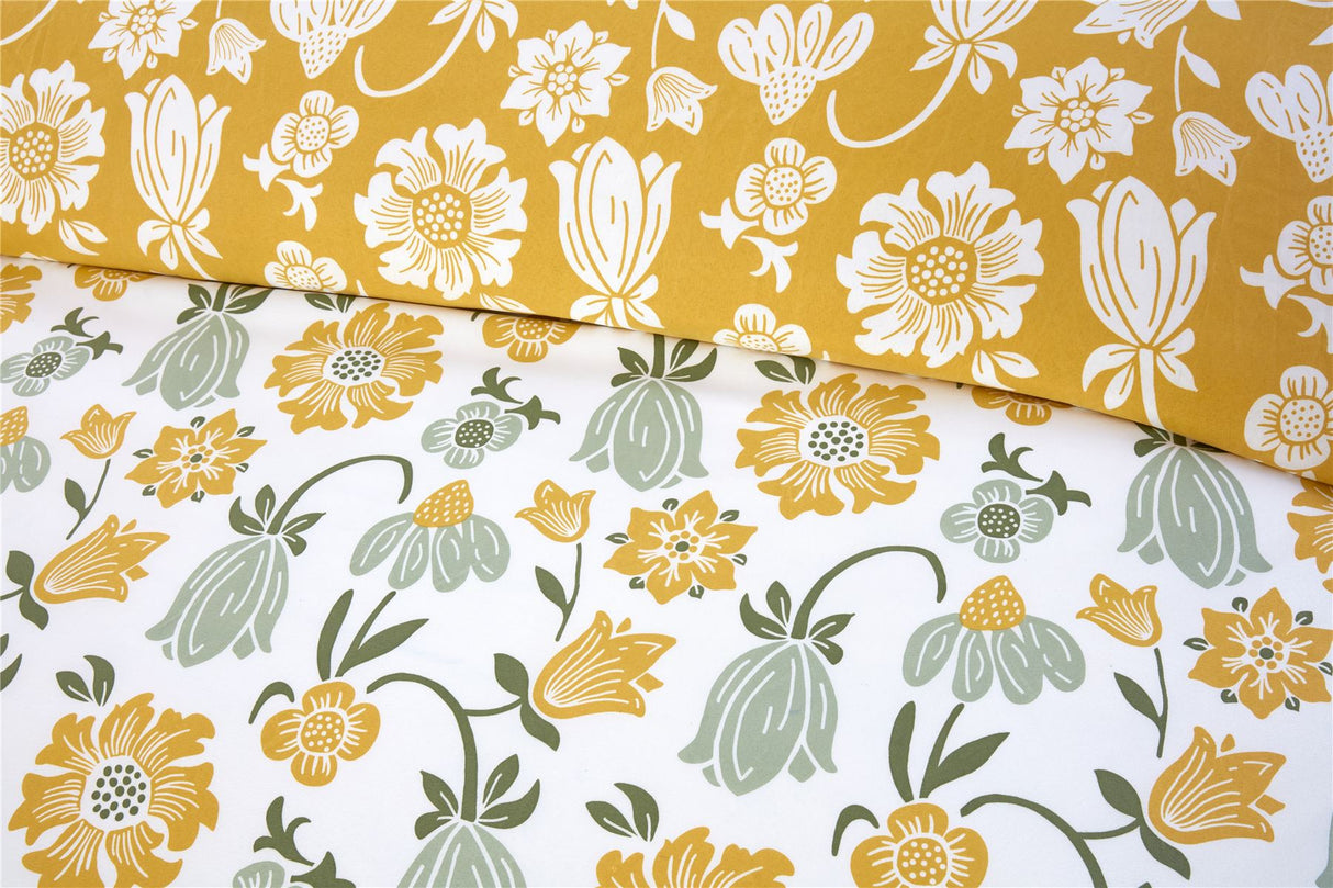 Vintage-inspired Victorian Bloom duvet set with vibrant pastel floral patterns in pink, yellow, and blue and a soft blue reverse for subtle elegance
