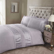 Close-up of Aurora Duvet Set showcasing intricate floral embroidery and button closure