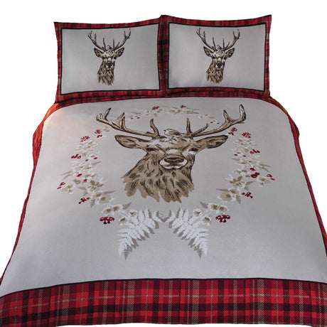 Detailed view of the duvet set showcasing a bold stag head motif encircled by winter berries, foliage, and a robin, perfect for cosy winter nights