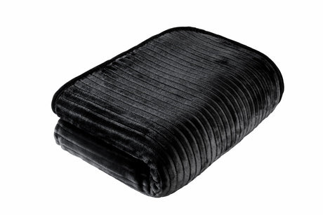 Stylish sofa adorned with a vibrant ribbed faux fur blanket for a chic home décor accent