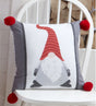 A festive Gonk Filled Cushion featuring two different gonk designs in simple winter colours, embellished with chunky pompoms at each corner, adding a fun and quirky Scandinavian-inspired touch to seasonal decor