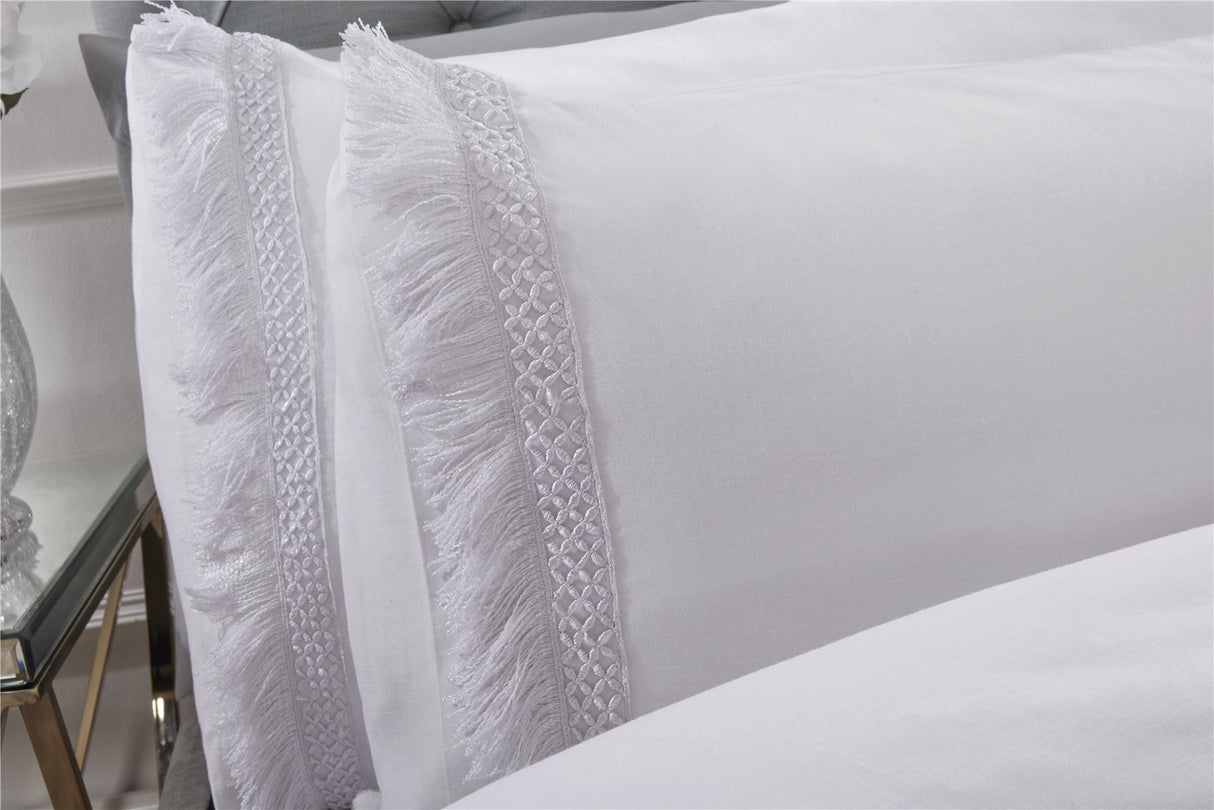 Kingsize Tia Trellis duvet cover displayed with contrasting lace fringe detailing on the edges and button fastening
