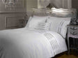 Detailed view of the Crystal Duvet Set’s head panel, featuring sparkling diamante embellishments on a silver faux silk background