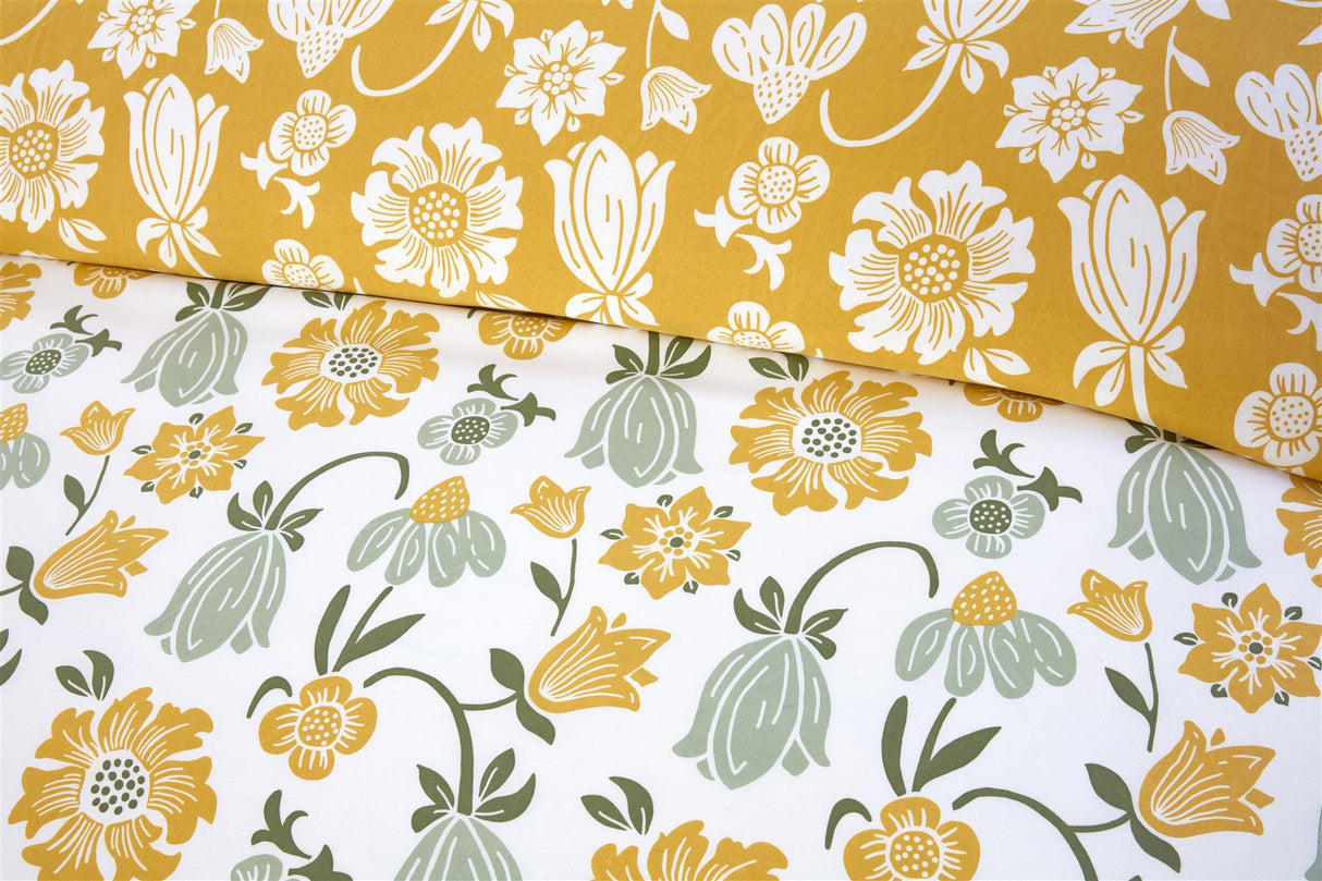 Victorian Bloom duvet set featuring cheerful yellow and green floral motifs on a white background, with a warm mustard reverse for a cosy feel