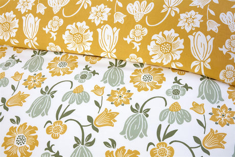 Victorian Bloom duvet set featuring cheerful yellow and green floral motifs on a white background, with a warm mustard reverse for a cosy feel