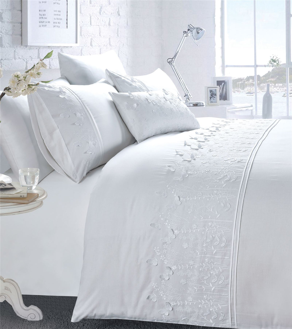 Close-up of the embroidered butterfly border showcasing intricate stitching on the bedding set