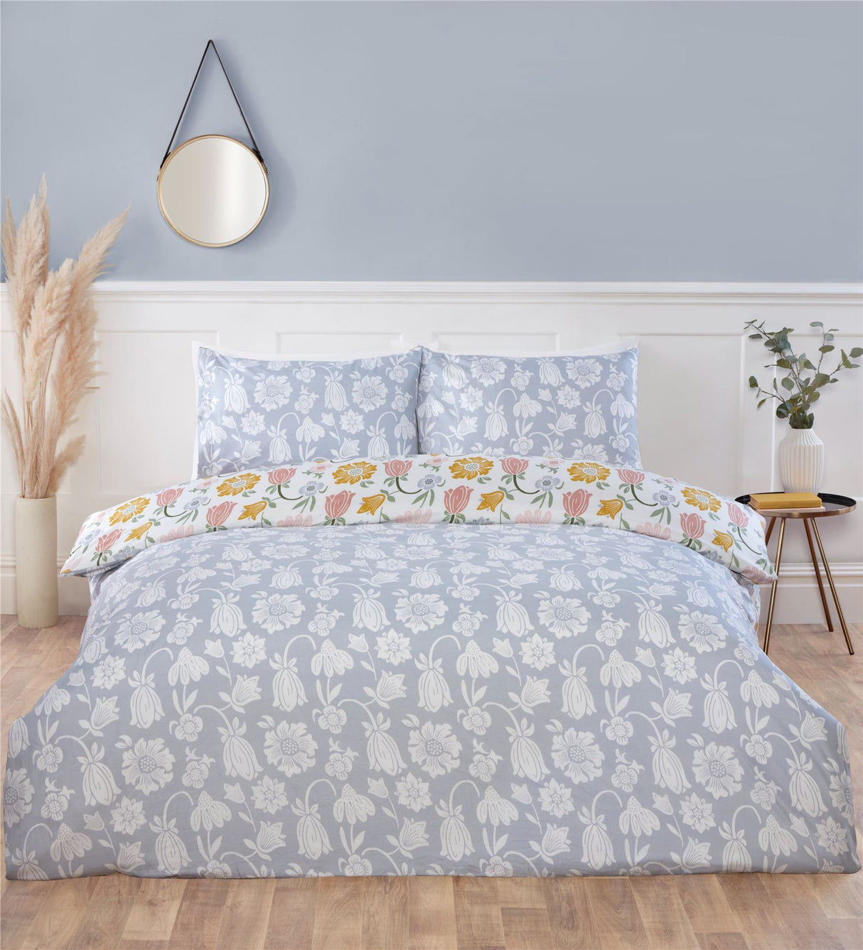 Elegant Victorian Bloom duvet cover featuring pastel pink, yellow, and blue floral patterns with a soft blue reverse for timeless bedroom style