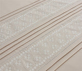 Elegant Charlotte Duvet Set featuring refined floral embroidery and subtle pleated design on neutral bedding