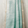 Stylish teddy throw casually placed on a sofa, highlighting its cosy and decorative appeal