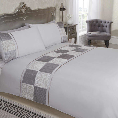 Luxurious mink coloured Batiste Duvet Set featuring a top cuff band, ruched satin panels, damask jacquard squares, and satin ribbon finishing including a kingsize duvet cover and matching pillowcases