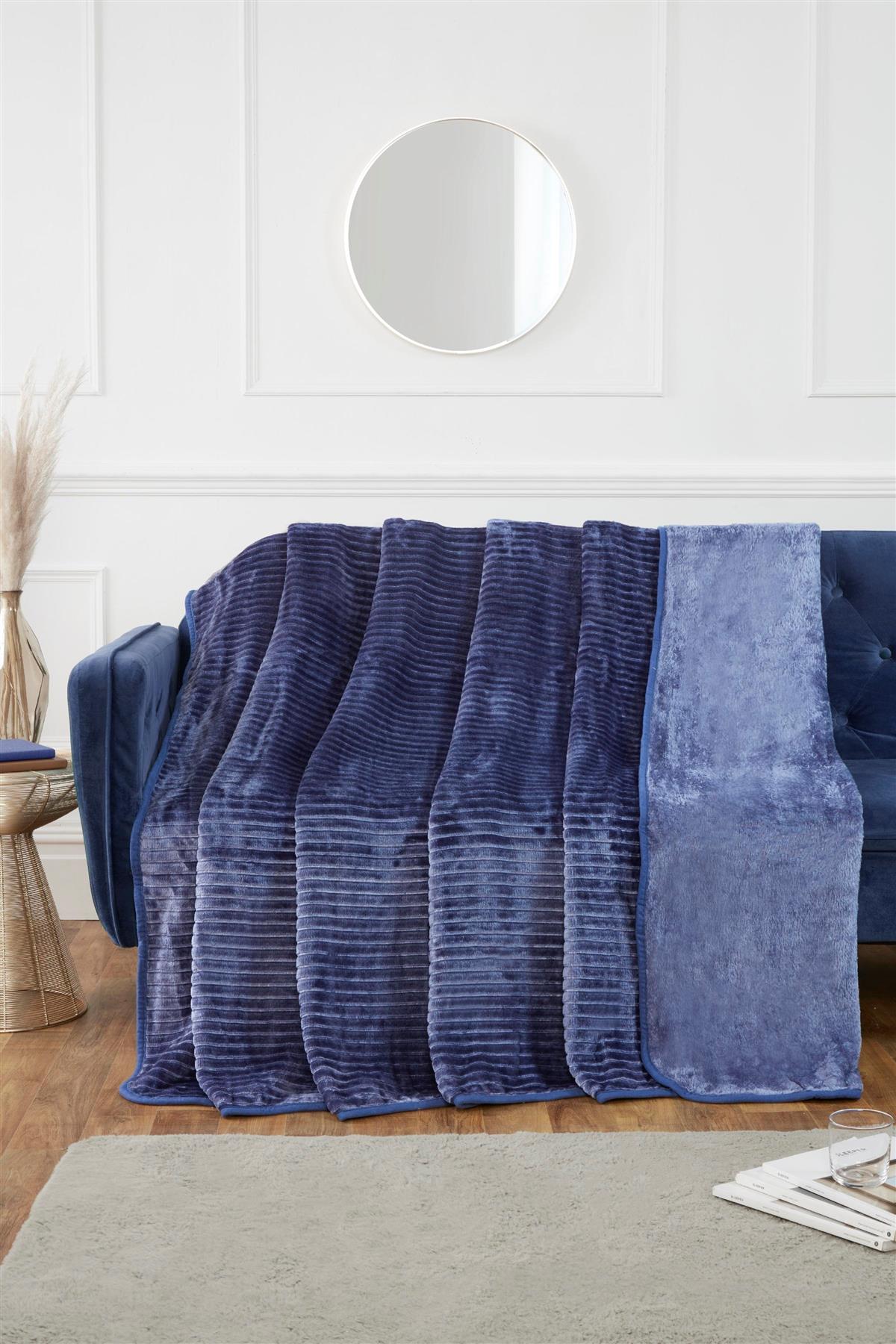 Decorative shot of the mink throw adding a layer of warmth and vibrancy to a modern bed