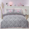 Colorful dalmation print duvet cover with bold pink trim and monochrome tones
