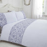 Close-up of the flower and butterfly design on the duvet cover with scalloped trim