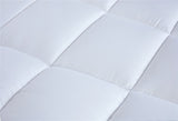 Close-up of a plush, expertly crafted luxury mattress topper with detailed stitching and premium microfibre material