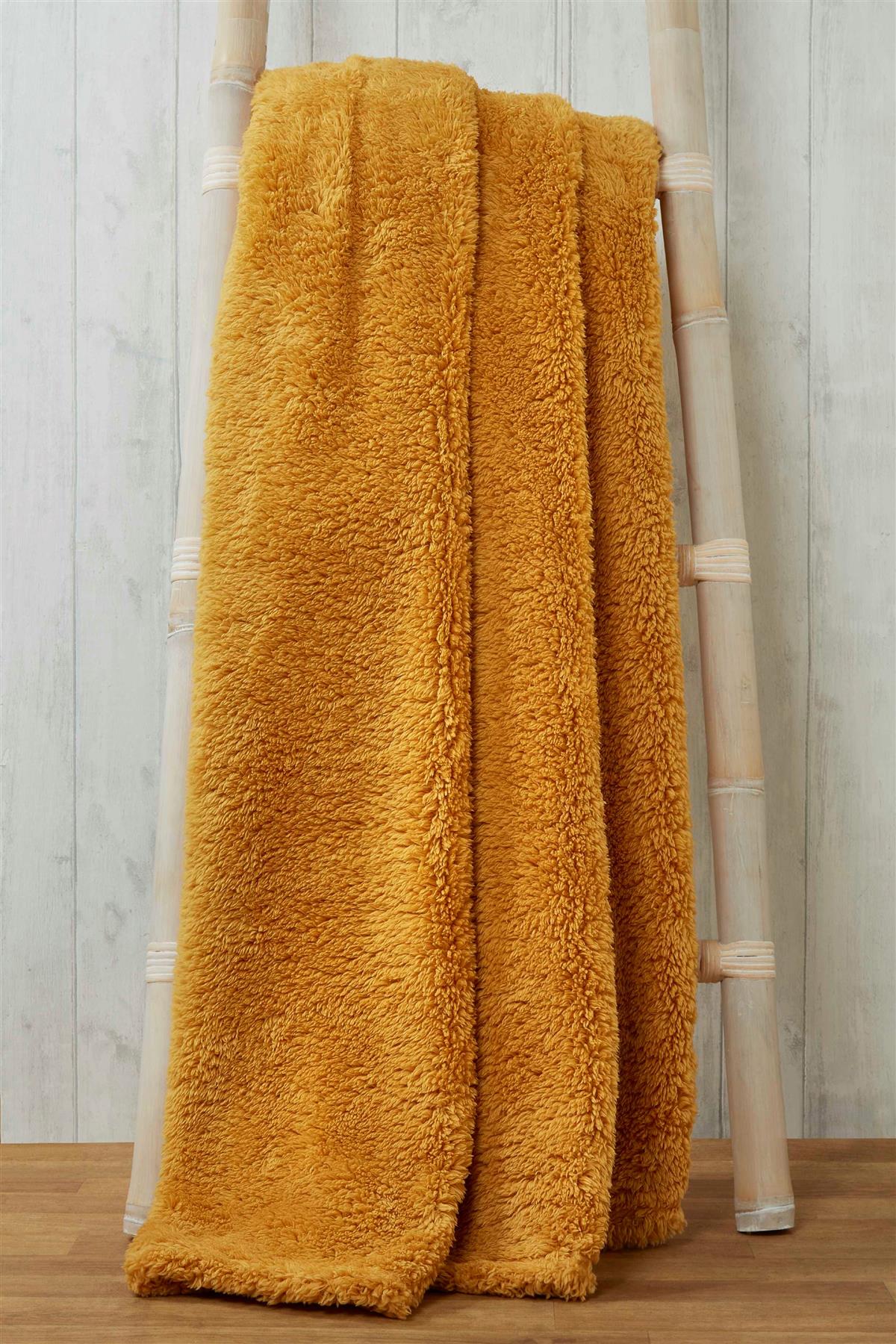 Close-up of soft, fluffy teddy throw with detailed stitching and textured fabric for ultimate comfort