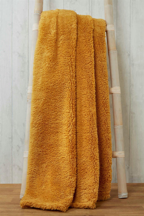 Close-up of soft, fluffy teddy throw with detailed stitching and textured fabric for ultimate comfort