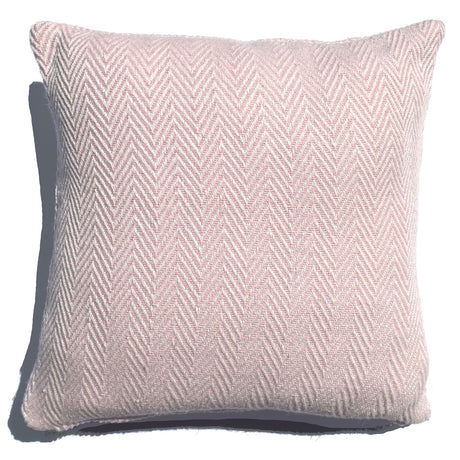 Soft-woven herringbone cushion in muted palette on a grey sofa