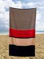 A large Hugo Beach Towel measuring 85x160cm featuring a red, cream, and blue block and stripe design, made from durable blended cotton, ideal for poolside or beach use and suitable for gifting