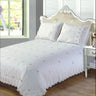 Intricately embroidered rose patterns on cream duvet cover with lace trim