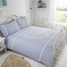Close-up of the heart design on the duvet cover featuring delicate embroidery and crochet lace trim