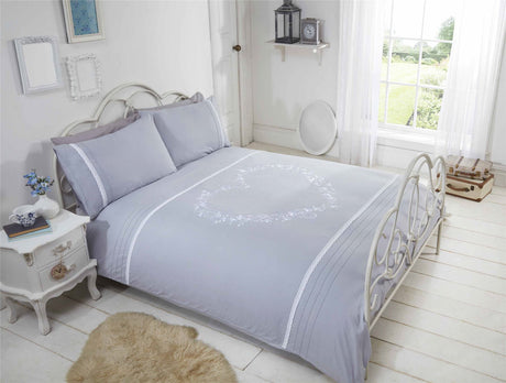 Close-up of the heart design on the duvet cover featuring delicate embroidery and crochet lace trim