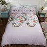 A detailed image of a Sloths Duvet Set featuring adorable illustrated sloths on a lilac background with floral accents and quirky slogan pillowcases, showcasing different sizes including single, double, and king with matching pillowcases, all made from easycare fabric with popper closures