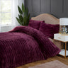 Close-up of the faux-fur fabric contrasting with smooth bed linen for a layered bedding look