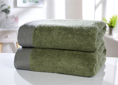 Collection including face cloths, hand towels, bath towels, and bath sheet, all with herringbone detail and plush cotton texture