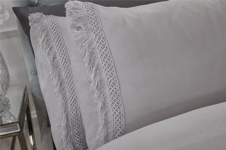 Detailed view of the Tia Trellis duvet cover highlighting the contrasting lace fringe trim on the duvet and pillowcases