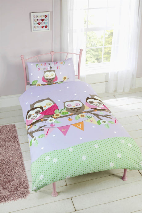 A lilac duvet set featuring a cute family of sleeping owls on a tree branch with bunting spelling out love, designed for a cosy bedroom