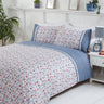 Close-up of the Penelope Duvet Set showcasing elegant spring flowers and vintage lace accents