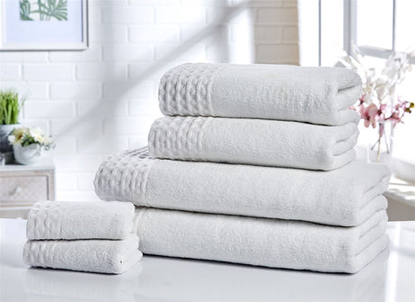 Luxury bath towels with hotel-style waffle trim, crafted from 100% pure cotton for a revitalising experience