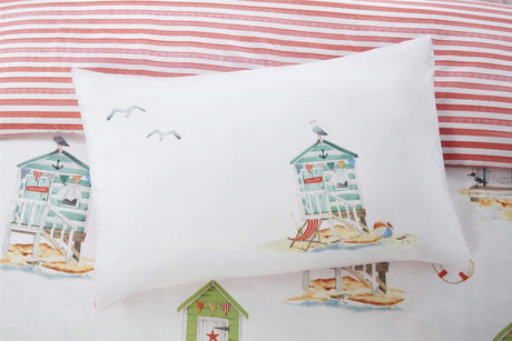 Reversible Padstow bedding with coastal seaside stripe on one side and beach huts with seagulls design in watercolour tones, crafted from soft, durable microfibre for a cosy sleep