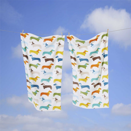 Long, soft velour bath towel featuring a fun sausage dog design