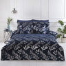 A navy-blue filled cushion featuring silver foil printed leaves from the Como collection, measuring 43x43cm, with finely crafted detailing to enhance bedroom decor