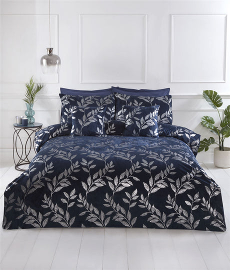 A navy-blue filled cushion featuring silver foil printed leaves from the Como collection, measuring 43x43cm, with finely crafted detailing to enhance bedroom decor