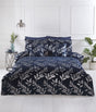 A navy-blue filled cushion featuring silver foil printed leaves from the Como collection, measuring 43x43cm, with finely crafted detailing to enhance bedroom decor