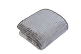 Muted lighting highlighting the rich texture and vibrant hue of the mink blanket